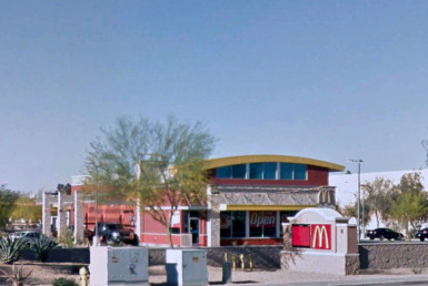 McDonalds storefront with cars at drivethrough