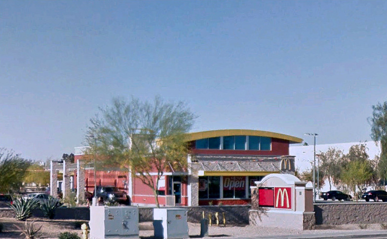 McDonalds storefront with cars at drivethrough